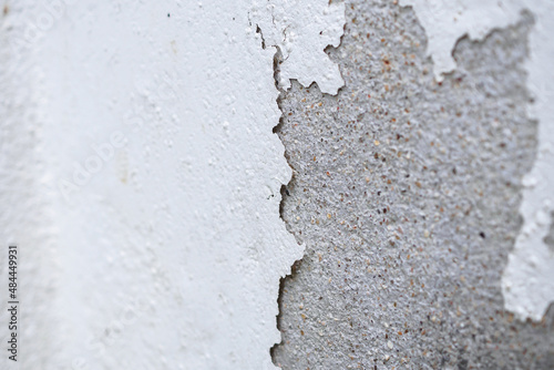 Abstract old white concrete wall with peeling paint