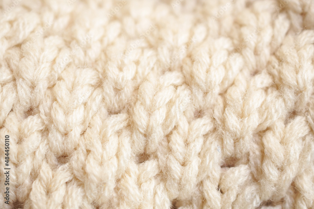 closeup beige knitted woolen fabric texture background closeup beige knitted woolen fabric texture background