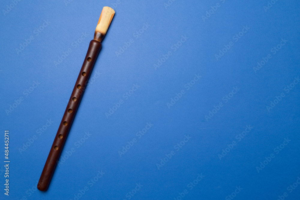 Armenian national musical instrument duduk on color background. Top view
