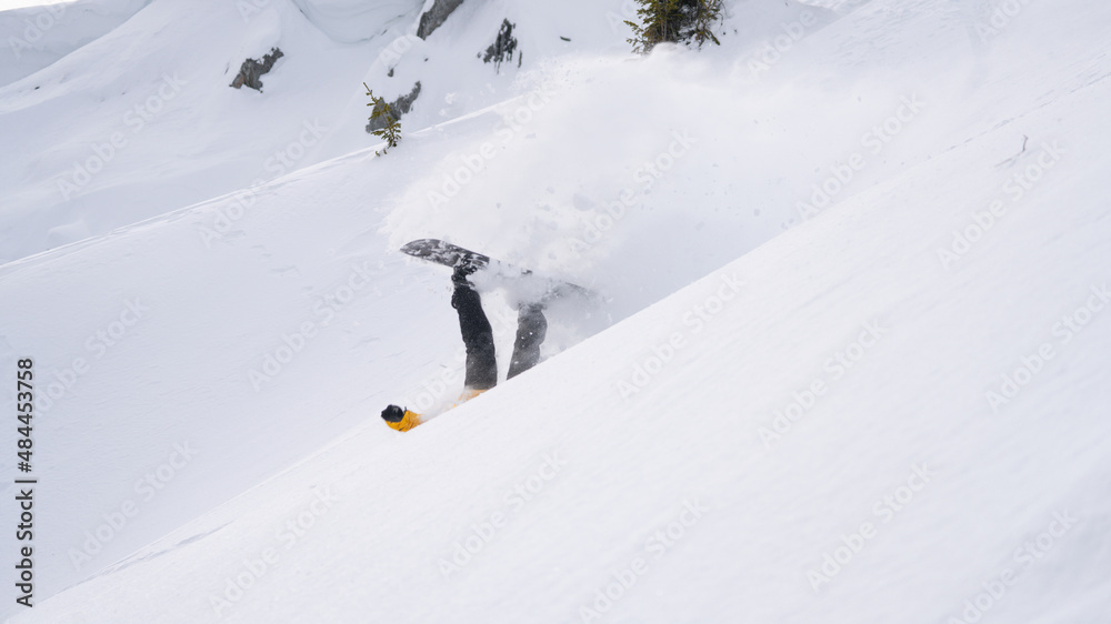Snowboarder falls on a snow-covered off-piste slope. Snowboarder falls on a snow-covered off-piste slope.