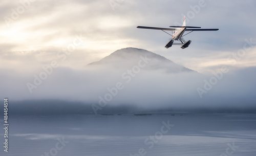 Seaplane flying over Canadian Mountain Nature Landscape on the Pacific West Coast. Cloudy and fog Winter Day. 3d Rendering Airplane Adventure Concept. Howe Sound, British Columbia, Canada.