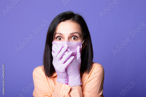 woman in a white shirt, pink medical mask and gloves