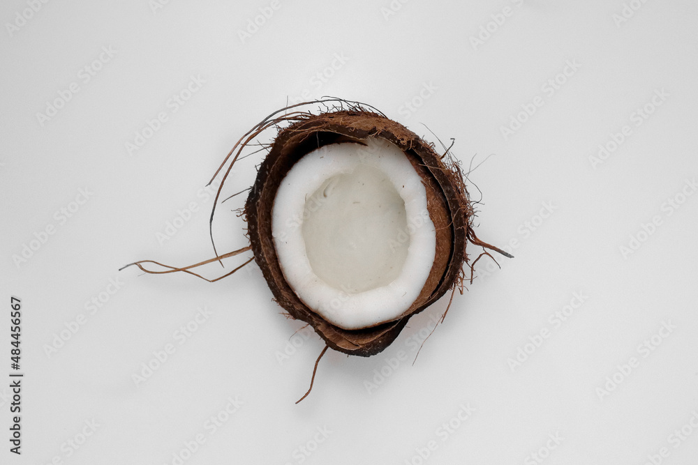 half of the coconut in the middle of a white background half of the coconut in the middle of a white background