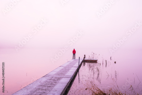 Obraz na plátne Man standing on jetty in mist