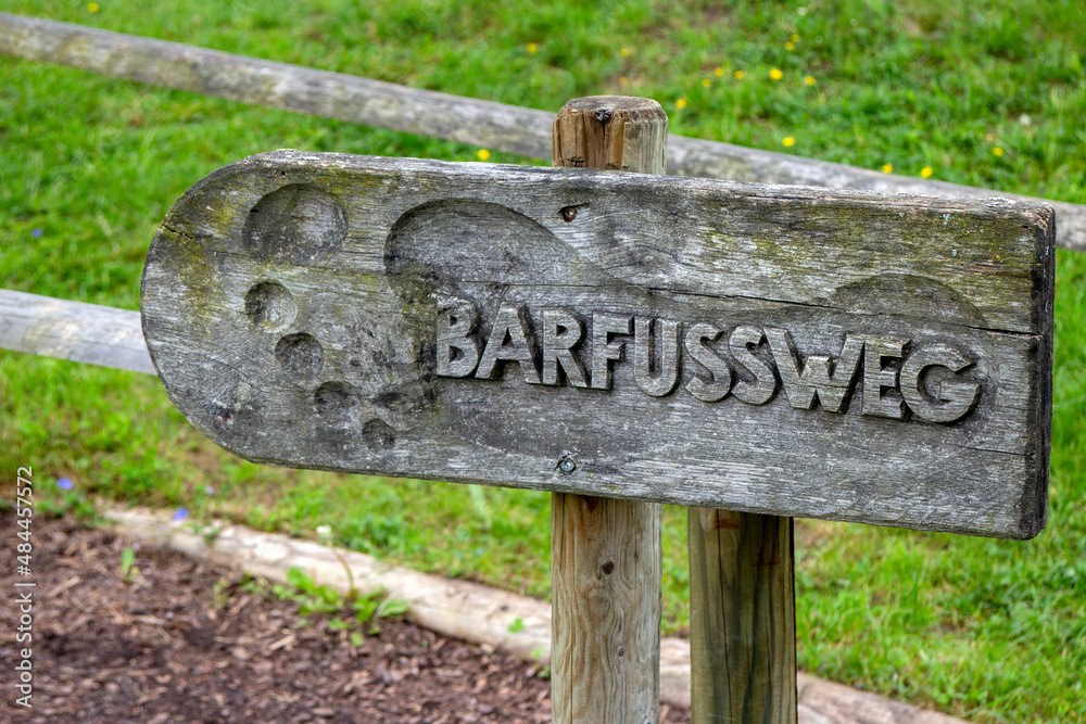 Old wooden sign with the German text 