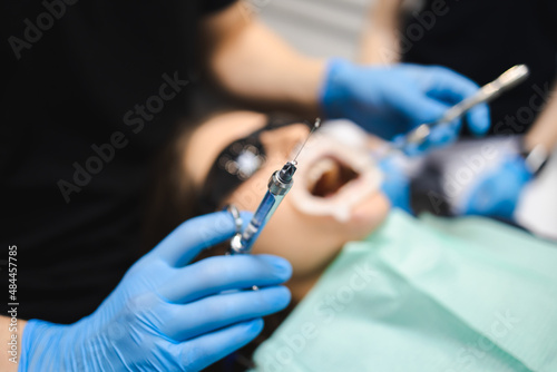 Dentist is going to inject anesthesia to the patient before starting dental treatment © Andrii 