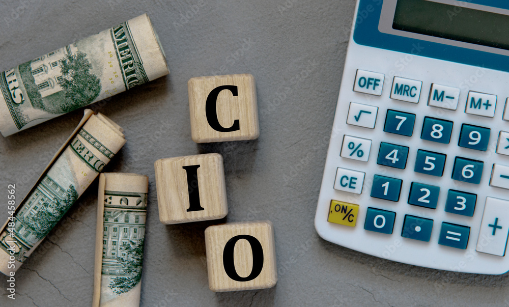 CIO - acronym on wooden cubes on a gray background with a calculator and  banknotes. foto de Stock | Adobe Stock