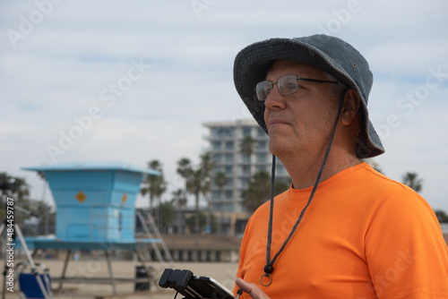 A Mature Man Flying a UAV Drone at Huntington Beach, California  © Gary Peplow
