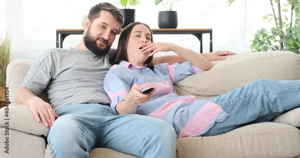 Couple spending leisure time watching tv at home Couple spending leisure time watching tv at home