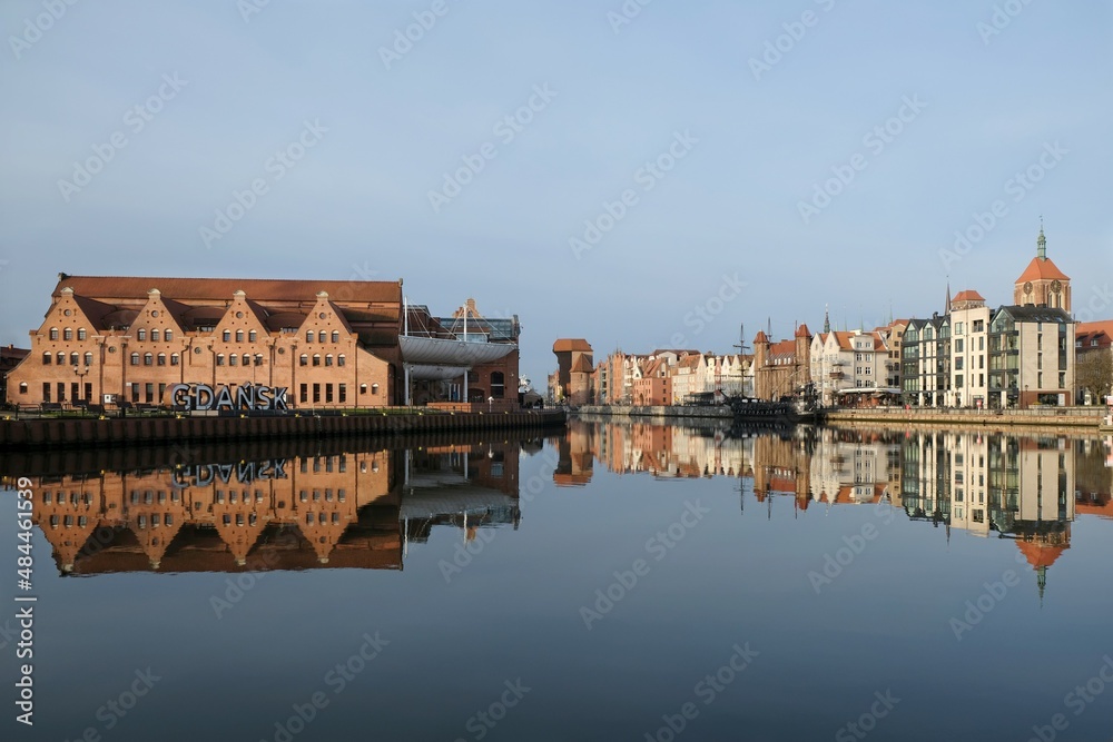 Panorama of Old Town in Gdansk and Motlawa river with ships, Poland. Amazing reflections in water. Letters of name of Poland on bank.