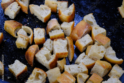 Close up of home-made croutons on a black baking tray