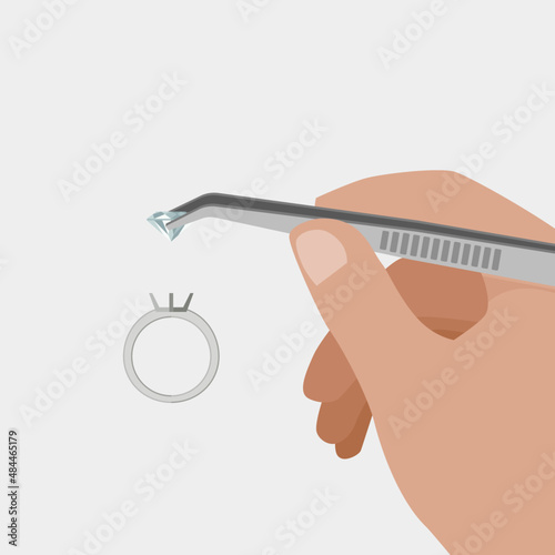 Jeweler at work making a ring. Inserting the diamond with tweezers into the setting.