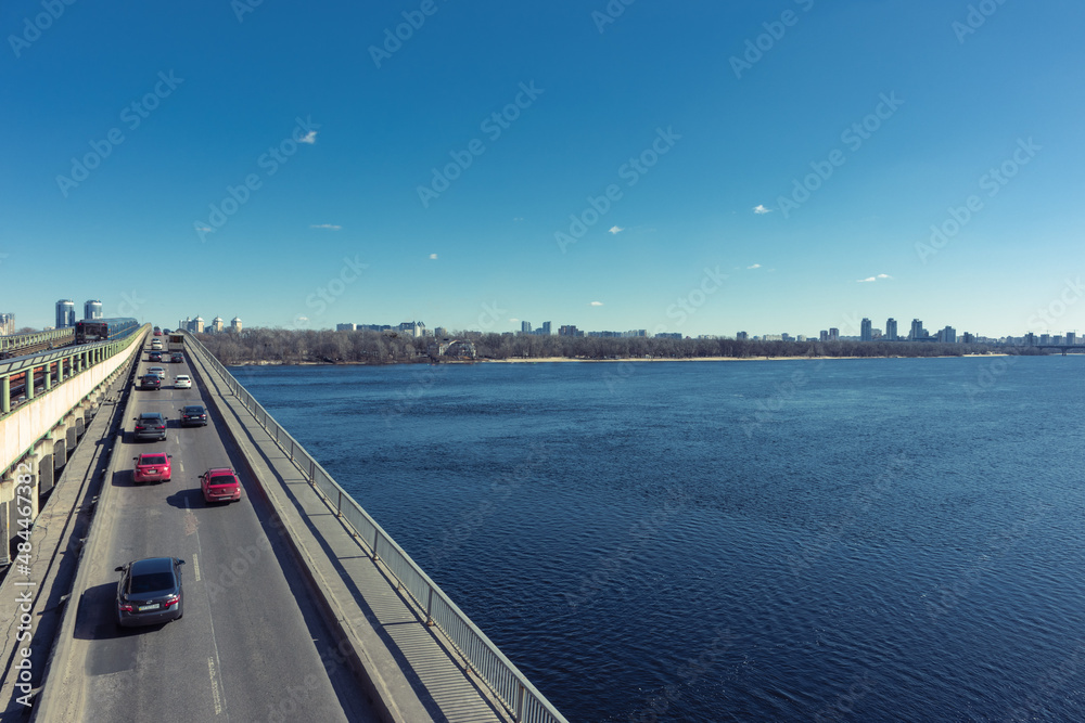 Long bridge across the wide river Dnieper. Metro bridge over the Dnieper River