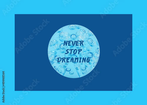 'Never stop dreaming' in a blue sphere with drops, isolated on a blue background.