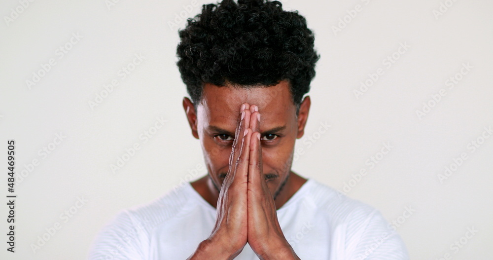 Smiling african person worshiping and praying having faith Smiling african person worshiping and praying having faith