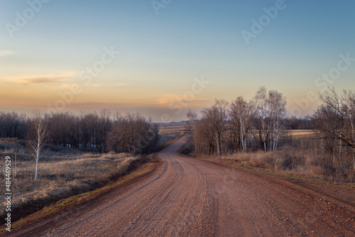 Road through ravine and forest in autumn. © Ilya