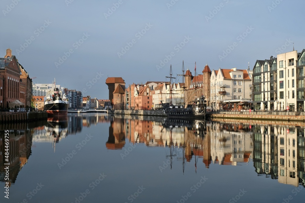Panorama of Old Town in Gdansk and Motlawa river with ships, Poland. Amazing reflections in water.