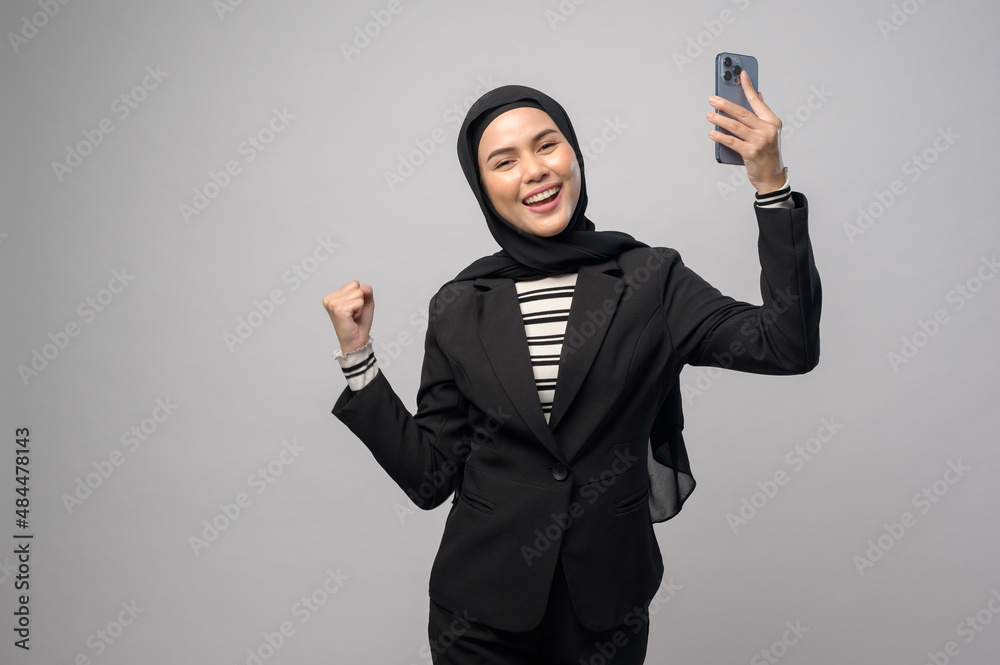 Portrait of beautiful woman with hijab using cellphone on white background Portrait of beautiful woman with hijab using cellphone on white background