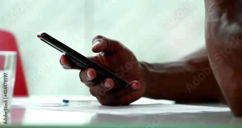 Close-up hand holding cellphone. African american hand using smartphone closeup