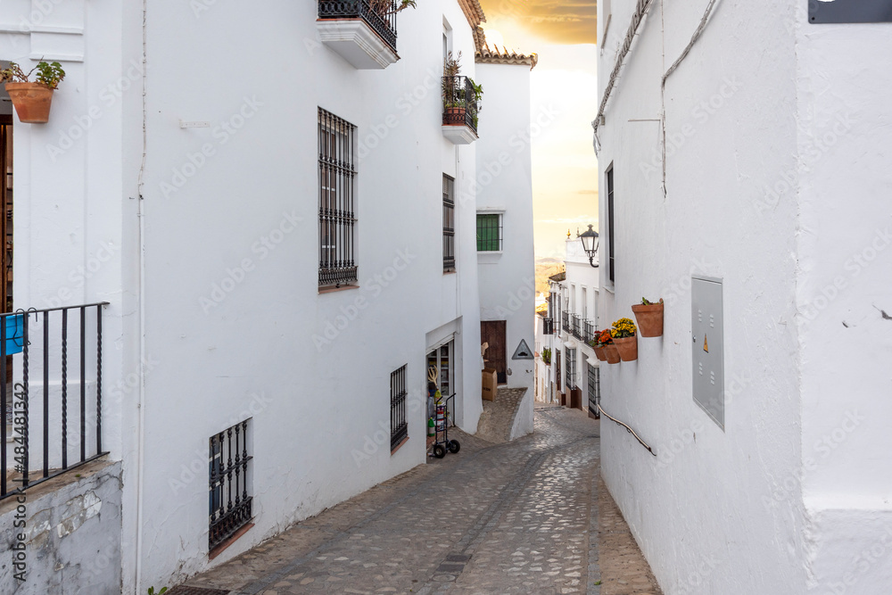 One of the many traditional hillside streets of white homes in the Andalusian White Village or Pueblos Blancos of Zahara de la Sierra.