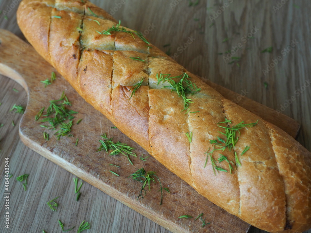 Garlic butter baguette. Crunchy sliced garlic bread on table. Filled garlic bread Garlic butter baguette. Crunchy sliced garlic bread on table. Filled garlic bread
