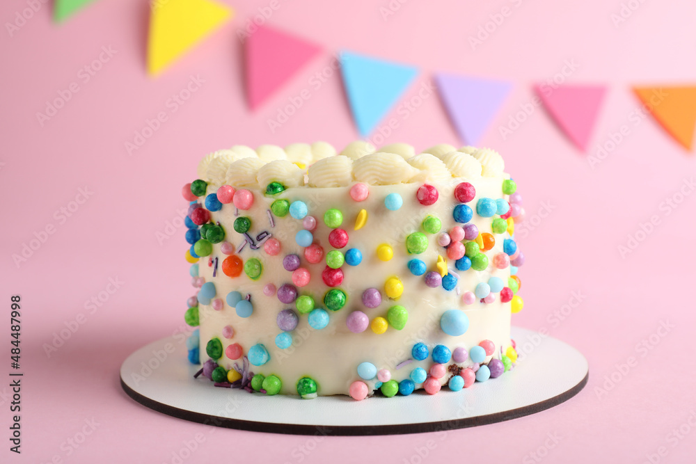 Cute bento cake with tasty cream on pink background Cute bento cake with tasty cream on pink background