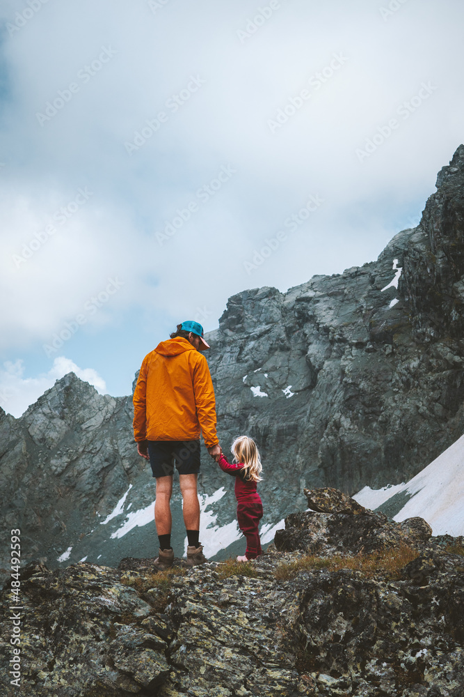 Father and child trekking in mountains family travel adventure ...