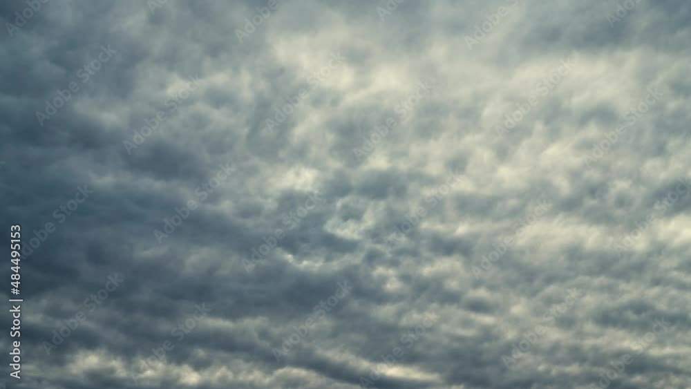 Dark and dramatic waving cloud formation across a background sky timelapse / time-lapse. 