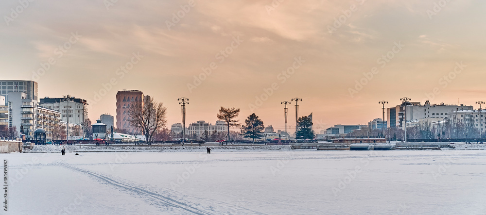 View of sights of downtown of Yekaterinburg, Russia, from ice of city pond, covered with snow. View of sights of downtown of Yekaterinburg, Russia, from ice of city pond, covered with snow.