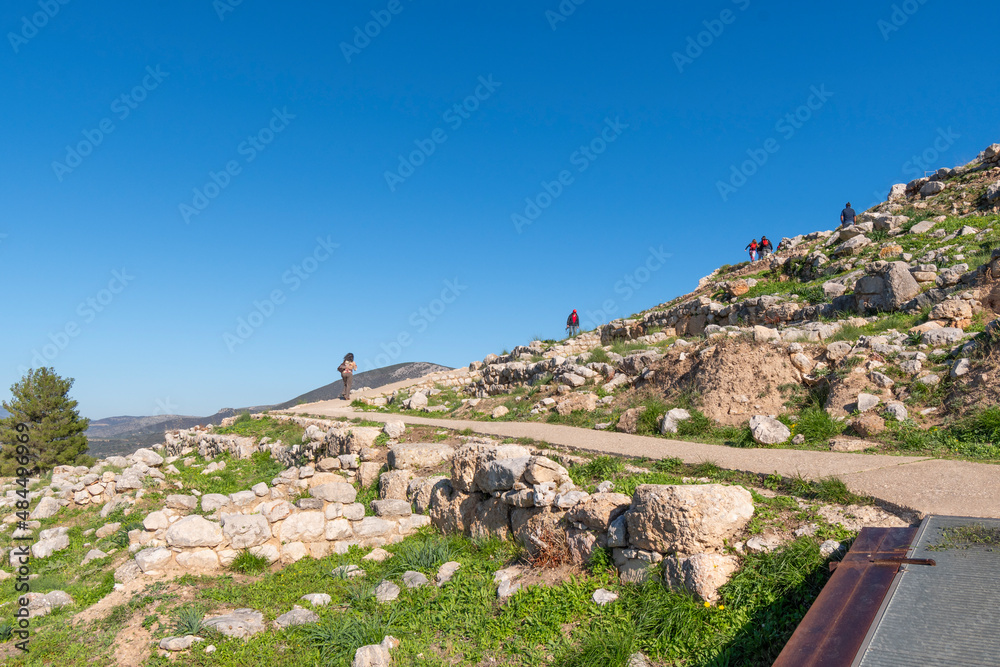 Tourists ascend the hill to the top at the Bronze age fortress of Mycenae, in Peloponnese, Greece.