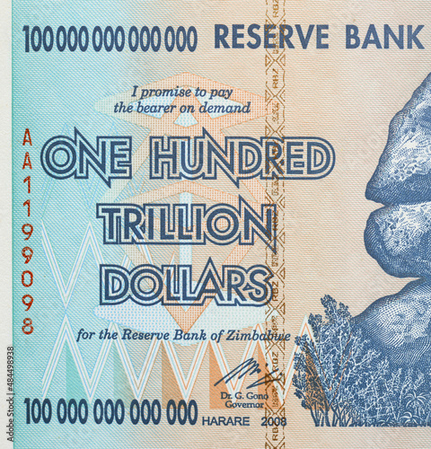 The text is onehundred trillion dollars close up on a Zimbabwe banknote.