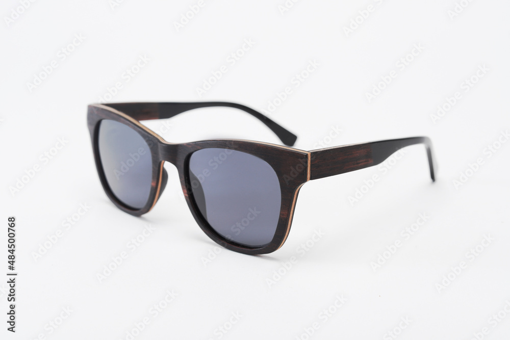 wooden sunglasses seen from the side on a white background wooden sunglasses seen from the side on a white background