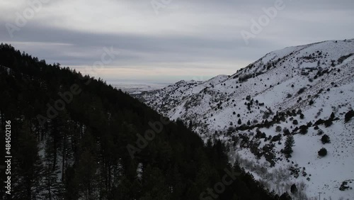 Drone flying through snowy Idaho canyon