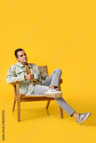 Young man resting with cup ...
