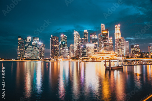 SINGAPORE, SINGAPORE - MARCH 2019: Skyline of Singapore Marina Bay at night with Marina Bay sands, Art Science museum , skyscrapers and tourist boats © Melinda Nagy