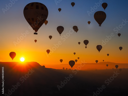Silhouette of hot air balloons in sky at sunrise nature background above the mountains at Cappadocia.
