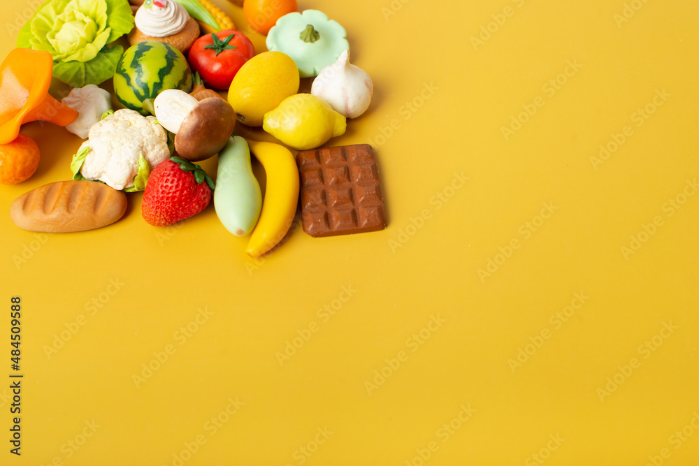 vegetables, fruits and sweets from polymer clay on a yellow background