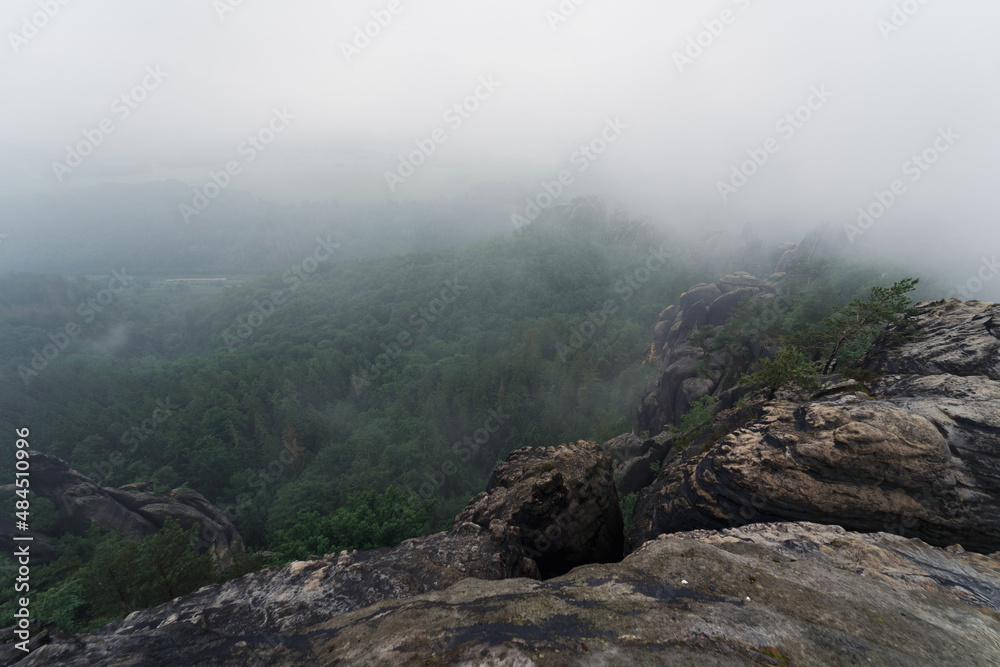 An early cloudy morning in mountain. Schrammsteine - group of rocks are a long, strung-out, very jagged in the Elbe Sandstone Mountains located in Saxon Switzerland in East Germany.