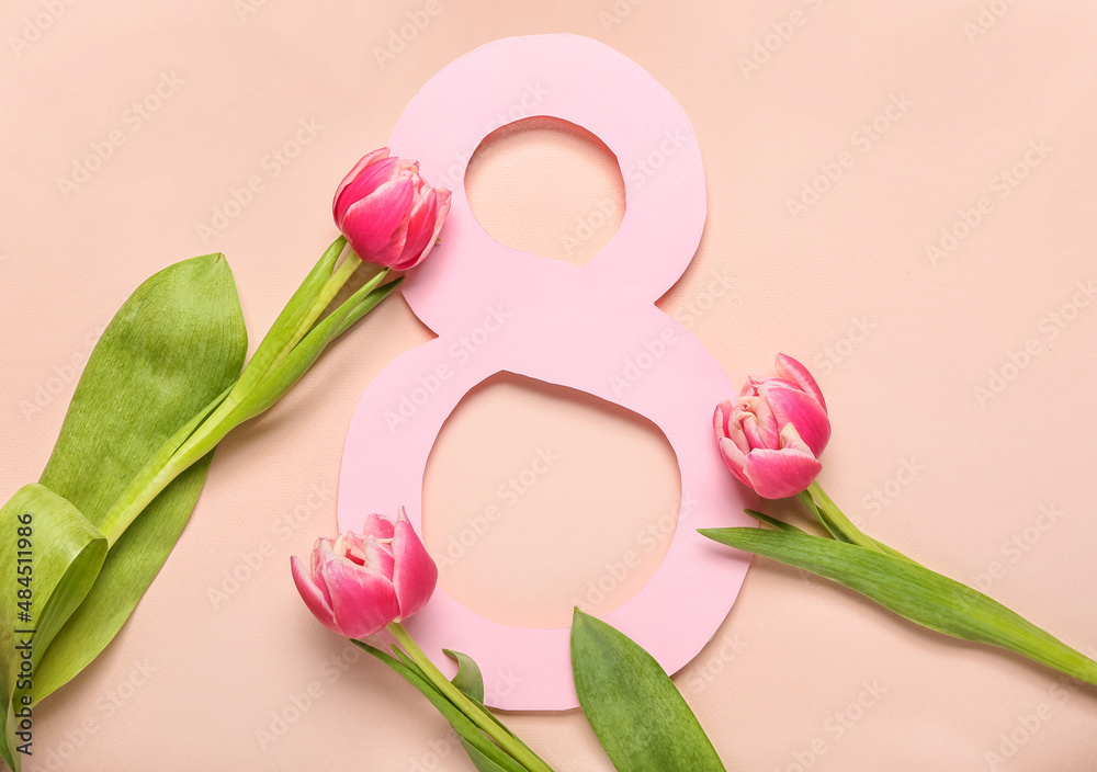 Greeting card for International Women's Day with flowers on pink background