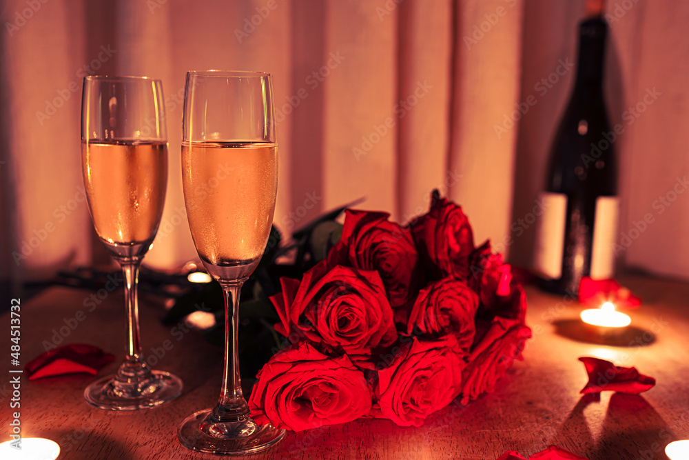 Romantic date setting with Champagne, roses and candle light, Valentine's Day background. Romantic date setting with Champagne, roses and candle light, Valentine's Day background.