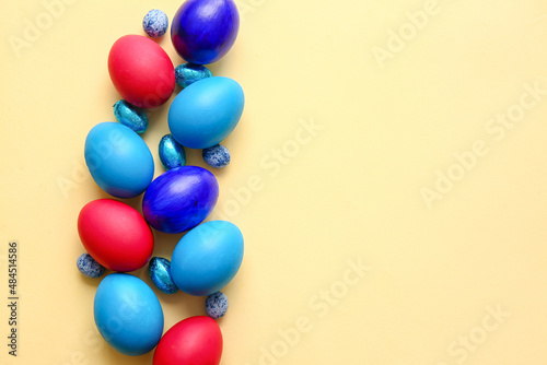 Different painted Easter eggs on light background