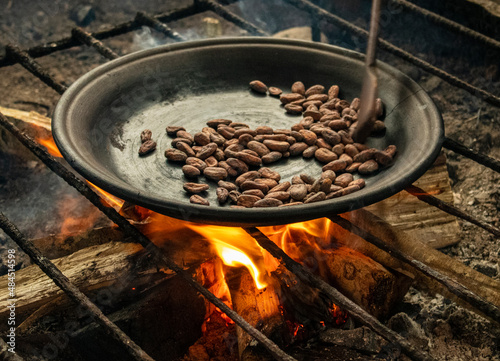 Cocoa beans toasted with firewood on a clay pan to make the traditional ancestral chocolate prepared by the amazon kichwa communities in Ecuador.  photo