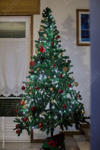 Christmas tree with different colors in the corner of the living room. © GeorgeVieiraSilva