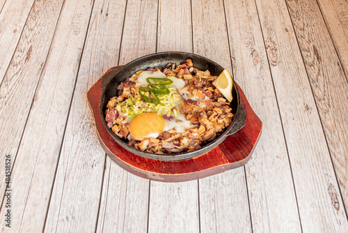 Sisig is a Filipino food of Pampanga origin. It is made with pig's head and liver, and is regularly served with hot peppers and calamansí. Sisig was invented by Lucia Cunanan