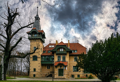 Ancient mysterious mansion against the backdrop of a stormy sky