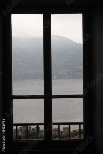 Closed window with breathtaking landscape view to lake como, italy