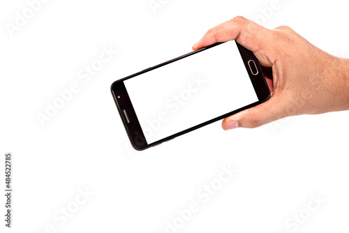 male hand holding cellphone black smartphone in horizontal position filming or photographing something , isolated white background, empty screen for mockup, copy space