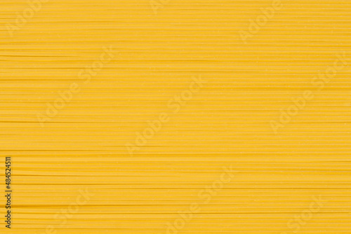 Raw thin spaghetti in rows, italian pasta. Food background concept