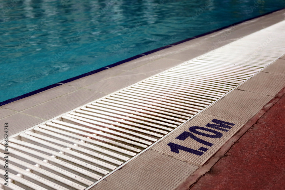 Sign of depth of the swimming pool, with clearly blue water in the pool.  Sport, recreation, swimming concept