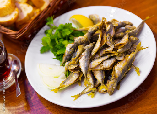 Dietary mullet fish. Fried fish in a plate with parsley and lemon. Turkish cuisine